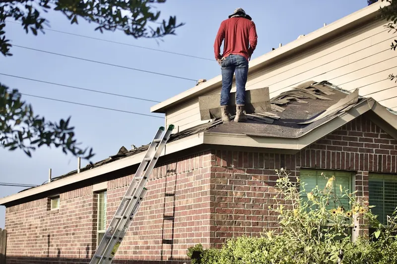 Professional roofer working on a residential roof in Park East
